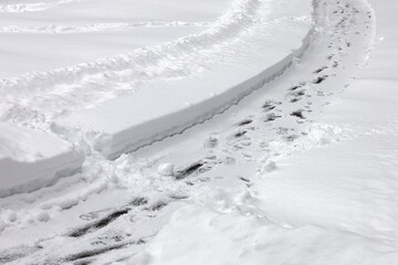 Pedestrian pathway with footprints covered with snow in winter. Snowy day