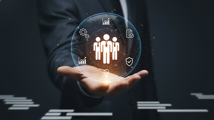 Businessman holding hands showing glowing sphere with human resources icons teamwork light bulb security data analysis