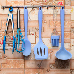 blue kitchen utensils on a magnetic holder