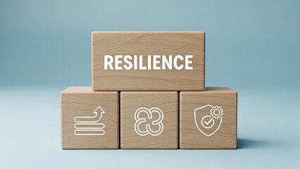 Resilience concept with wooden blocks and icons on blue background