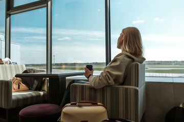 Digital nomad woman using smartphone in modern airport terminal, remote work and solo travel lifestyle,mobile office concept, freelance productivity, location independent work, modern travel routine.