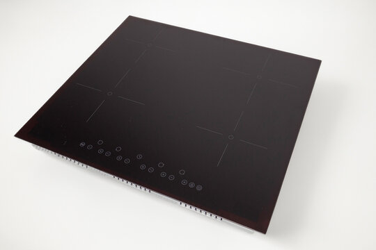 Black induction cooktop creating modern kitchen cooking technology