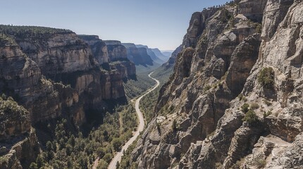 Dramatic mountain canyon with winding road and steep cliffs