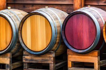 Wine or cognac barrels in the cellar of the winery, Wooden wine barrels in perspective. wine vaults. vintage oak barrels of craft beer or brandy