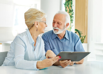 Senior couple having fun using a tablet computer