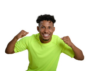 Excited young man celebrating his success with clenched fists.