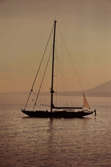 Silhouette of a elegant sailboat in the Mediterranean Sea at sunset time