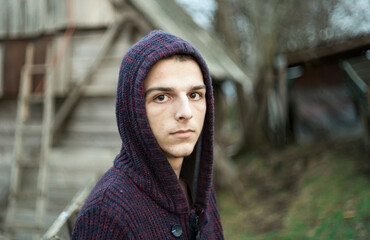 portrait of a young man with a hoodie outside