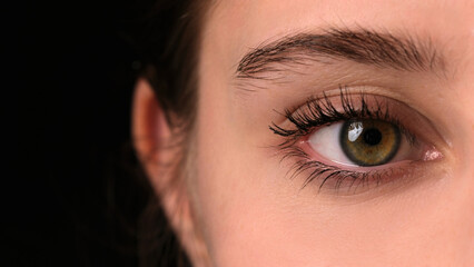 Girl Widely Opens Her Large Green Eye For A Close-Up View