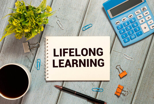 Never stop learning written on a memo stick. Lifelong learning concept