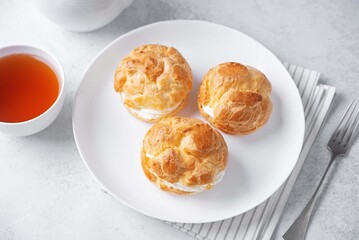 Profiteroles with cottage cheese filling in a plate
