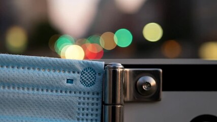 A close-up image of a blue mask on a street corner, symbolizing health and safety in urban life during challenging times.