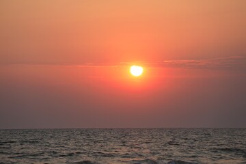 Fototapeta premium Picturesque sky with sun over sea at sunset