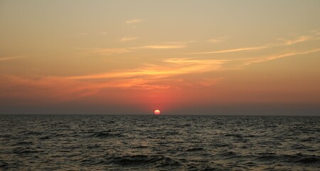 Fototapeta premium Beautiful sky with sun over sea at sunset