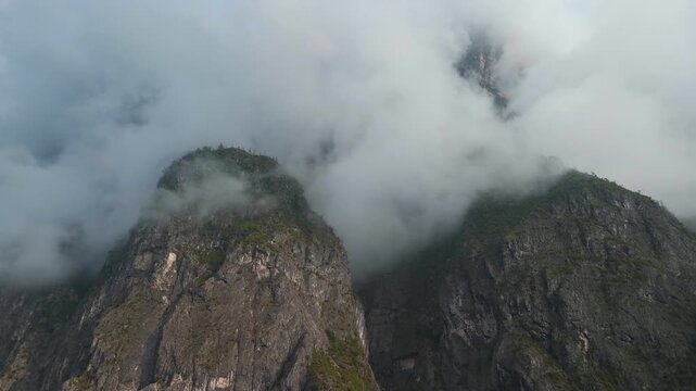 Foggy mountain peaks and valley landscape in the Dolomites, Italy