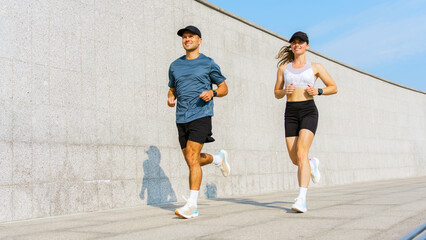 Couple jogging on a running path in a city