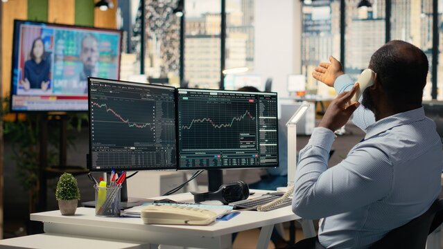 Stockbrokers worried by Black Swan event causing global disruption, alerting customers. Prop firm traders watch breaking news of crisis affecting stock market, desperately calling clients