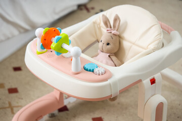 Baby walker on carpet in bedroom, closeup