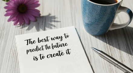 Inspirational quote on paper with a coffee mug and flower on a wooden table.
