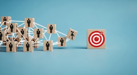 Wooden blocks with people icons connected forming a network leading to a target block representing business goals and teamwork.