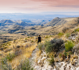 Obraz premium Female Hiker on The El Capitan Trail at Sunrise, Guadalupe Mountains National Park, Texas, USA