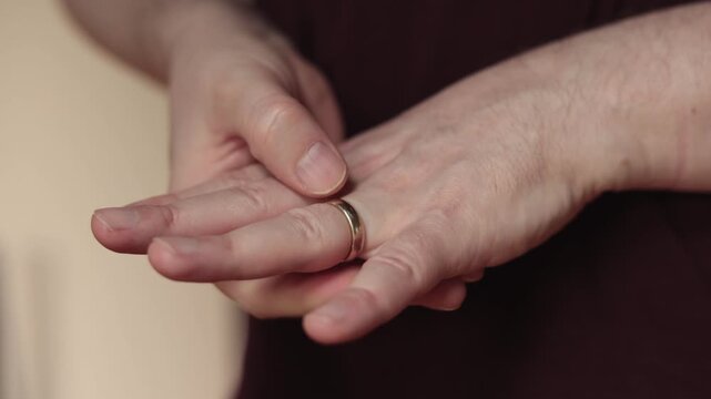 Close-Up Slow Motion of Man Nervously Fidgeting with Wedding Ring on Finger