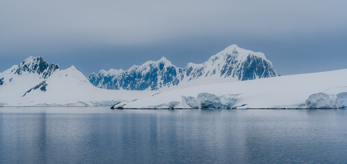 Neumayer Channel Antarctica Palmer Archipelago Dramatic Cliffs Snow Covered Mountains Calm Ocean. Beautiful Natural Landscape Remote Destination © And They Travel