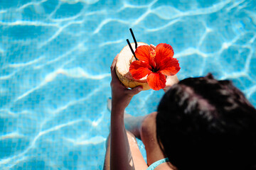 Coconut Drink Garnished with Hibiscus Flower by Poolside
