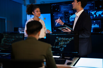 Automotive engineer presenting electric car design on large digital screen. Technical team analyzing vehicle aerodynamics and engine performance data in high-tech laboratory.