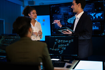 Industrial design team planning future transport strategy. Executive presenting new smart mobility concept and market trend analysis on digital board during late night workshop.