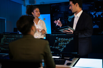 Industrial design team planning future transport strategy. Executive presenting new smart mobility concept and market trend analysis on digital board during late night workshop.