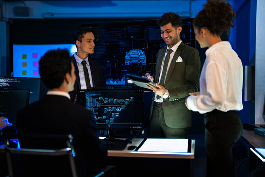 Industrial design team planning future transport strategy. Executive presenting new smart mobility concept and market trend analysis on digital board during late night workshop. - Powered by Adobe