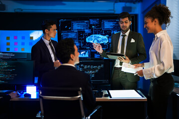 Automotive engineer presenting electric car design on large digital screen. Technical team analyzing vehicle aerodynamics and engine performance data in high-tech laboratory.
