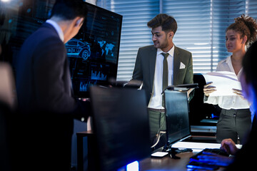 Automotive executives discussing electric car market strategy. Business leadership team analyzing vehicle sales data and future design trends in modern night office.