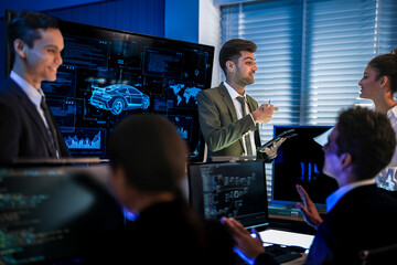 Industrial design team planning smart mobility transport. Professionals analyzing futuristic car prototype and engineering schematics on digital screens at night.