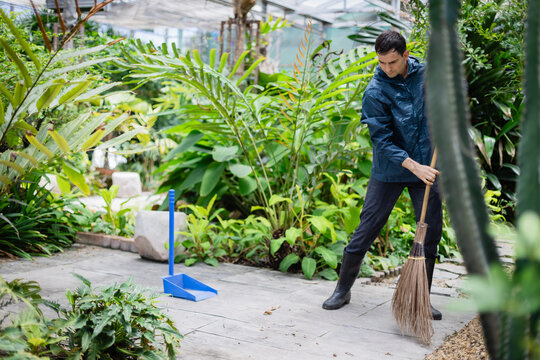 Young scientist in farm greenhouse is part of agricultural research team working diligently to maintain environment and support plant growth with care and focus - Powered by Adobe
