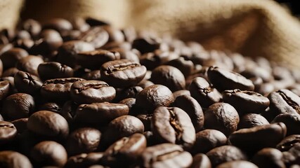 A captivating closeup shot reveals a rich dark pile of freshly roasted coffee beans showcasing their intricate textures and inviting aroma ready for grinding and brewing into a delicious energizing b.