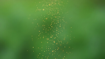 Abstract green background with golden glitter particles floating in the air.