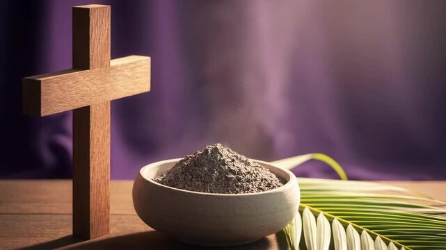 Christian wooden cross and bowl of ashes with palm leaf on wooden table. Symbol of ash wednesday and lent season. Reminder of mortality.