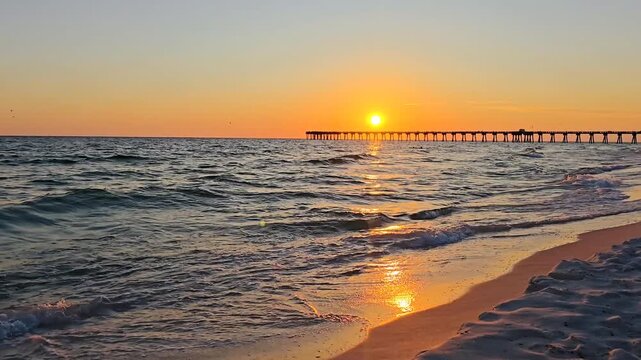Scenic ocean waves at beautiful sunset with pier in the background