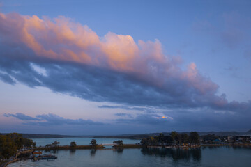 Scenic sunsets and colourful colonial architecture of historic center of Flores, Guatemala. View of lake Peten Itza, Flores Lake.