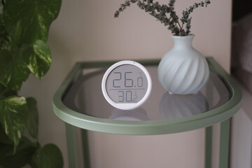 Thermometer on table showing temp and humidity