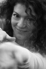 Obraz premium Happy and smile woman with curly hair. Black and white portrait. Smile and emotional