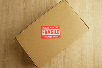 Box with fragile label sits on wooden surface