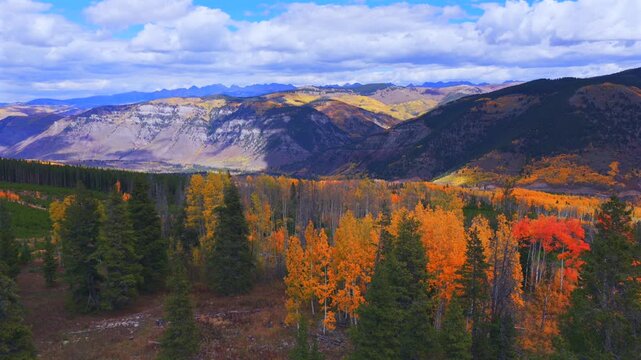 Mount of the Holy Cross Wilderness Sawatch Gore Range Minturn Red Cliff Gilman Vail parallax aerial drone Fall Autumn cloudy morning Rocky Mountains Colorado colorful Aspen trees forward pan up motion