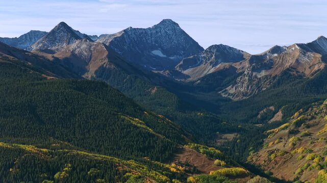Aspen Snowmass Capitol Peak Clark Peak Mt Daly creek trail wilderness Autumn Fall early morning blue sky sunny snowy Colorado aerial drone White River Forest Elk Range Rocky Mountains parallax left