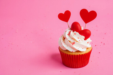 Happy Valentines day. Festive cupcake with red hearts on pink background. Concept for celebrations love. 3d rendering.