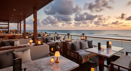Elegant beachfront lounge with comfortable seating and warm lantern lights at sunset, offering a peaceful ocean view and premium resort ambiance for travel, leisure, and lifestyle designs