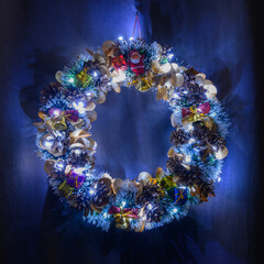 glowing christmas wreath on a dark background in the darkness