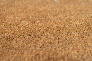 Close up of natural brown coir fiber texture with shallow depth of field. a warm brown color and a rugged, bristly texture.
